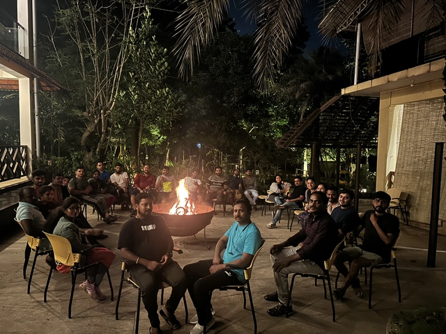 The Invenzo team around a fire pit at a resort