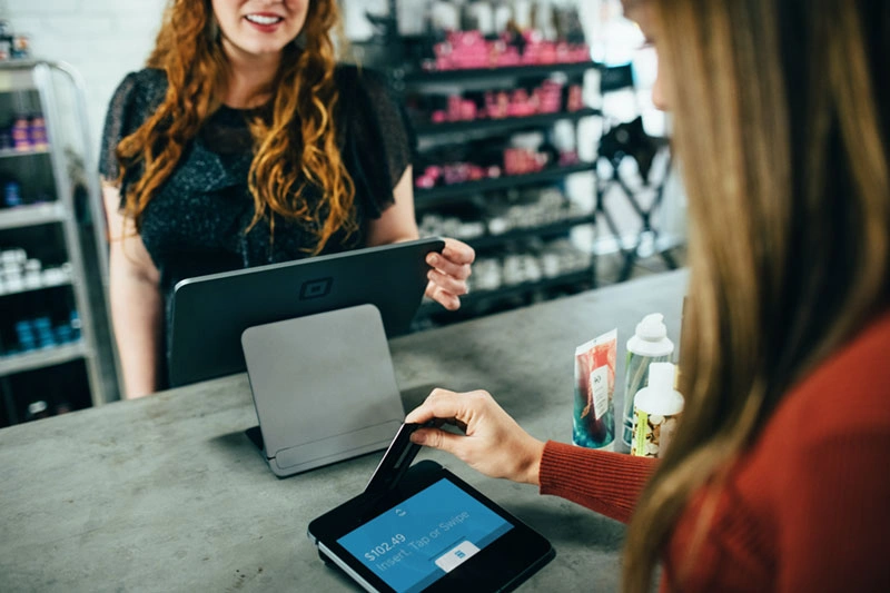 A pharmacist attending to a customer at the counter