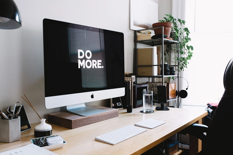 A desk workspace with a computer showing a productivity app